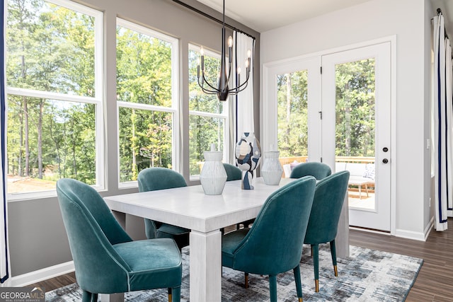 sunroom / solarium featuring an inviting chandelier