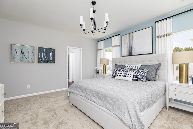 carpeted bedroom featuring an inviting chandelier