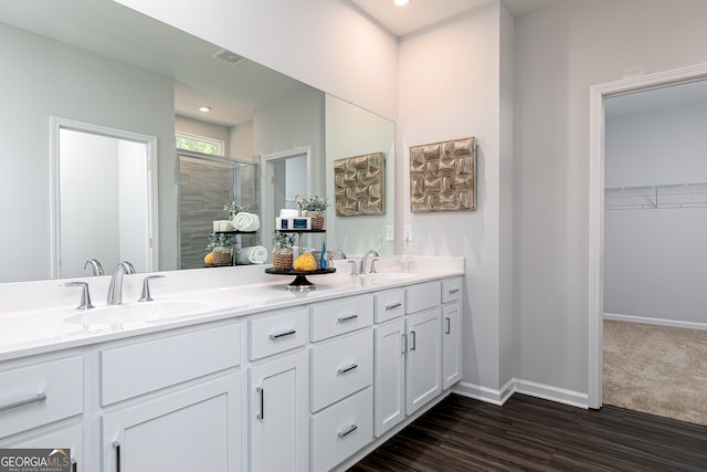 bathroom featuring hardwood / wood-style floors, vanity, and an enclosed shower