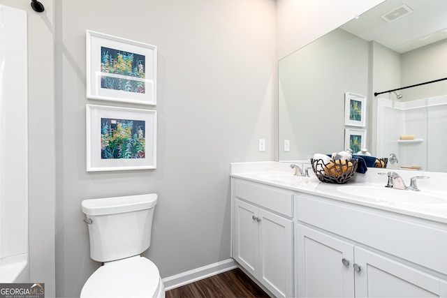 bathroom with vanity, hardwood / wood-style flooring, toilet, and walk in shower