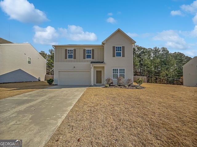 front of property featuring a front yard and a garage