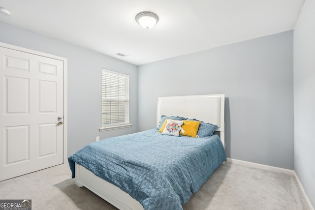 bedroom with light colored carpet