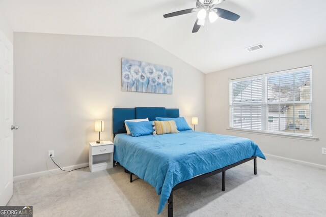 carpeted bedroom with vaulted ceiling and ceiling fan