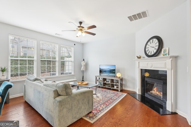 living room with dark hardwood / wood-style floors, plenty of natural light, and ceiling fan