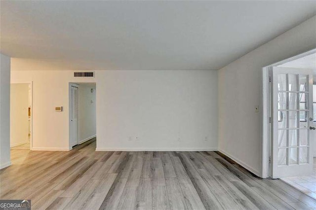 spare room featuring light hardwood / wood-style flooring