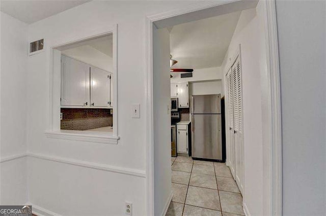 hall with light tile patterned flooring