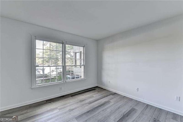 spare room featuring light hardwood / wood-style flooring