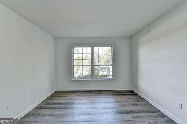 spare room featuring dark hardwood / wood-style floors