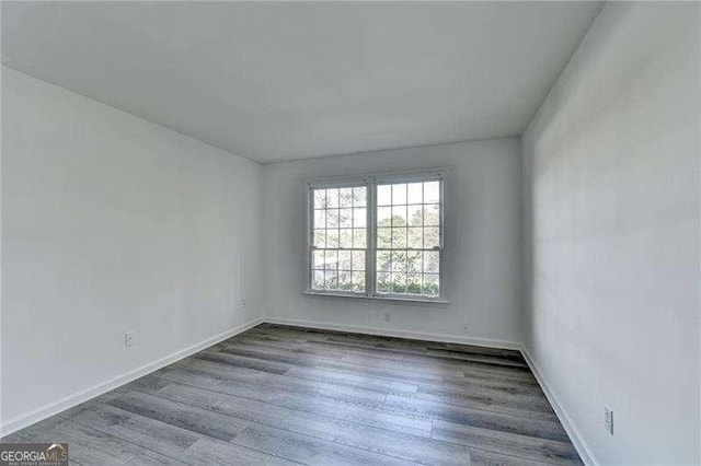 empty room with hardwood / wood-style floors