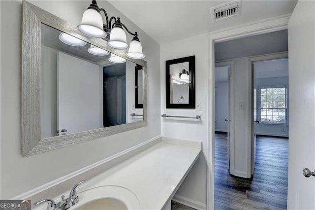 bathroom featuring vanity, wood-type flooring, and a chandelier