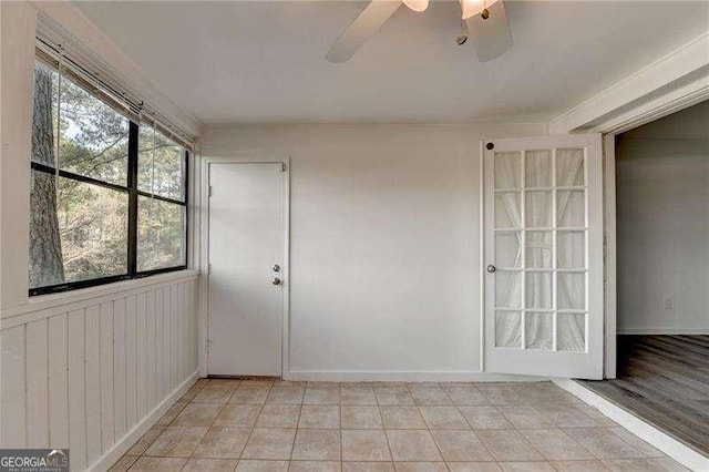 tiled empty room featuring ceiling fan