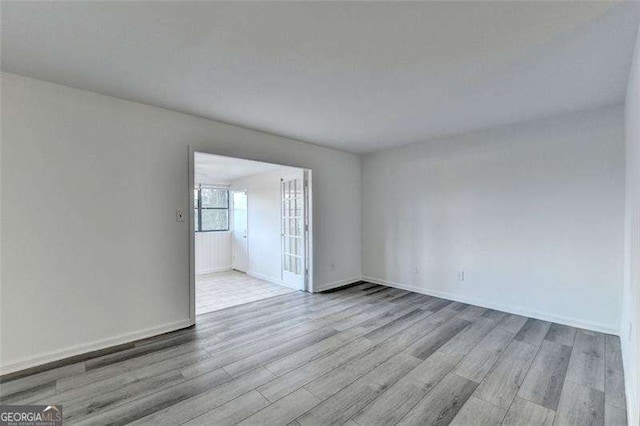 spare room with light hardwood / wood-style floors