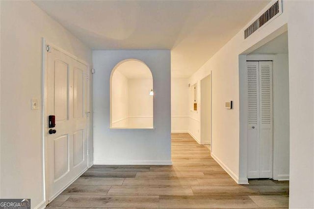 hallway with light hardwood / wood-style flooring