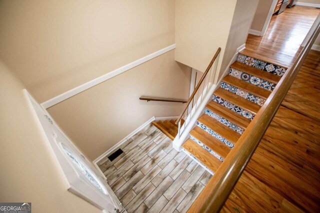 stairway with hardwood / wood-style flooring