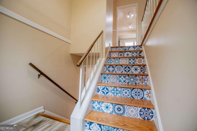 stairs with wood-type flooring