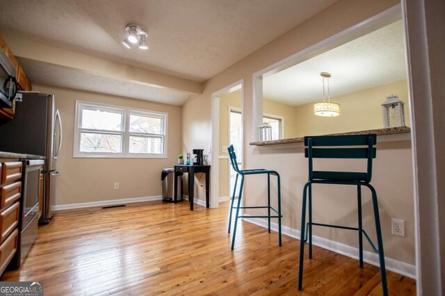 exercise room with light hardwood / wood-style floors