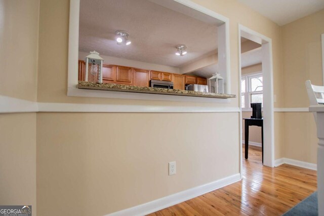 kitchen with light hardwood / wood-style floors and fridge