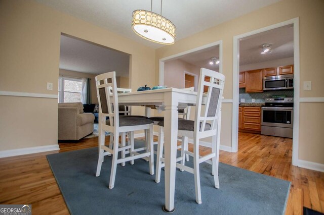 dining space with light wood-type flooring