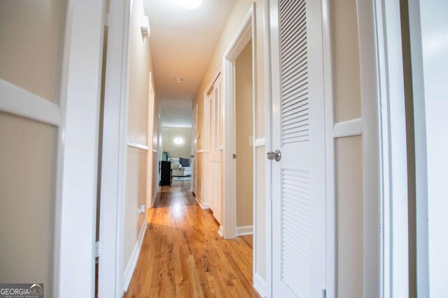 hall with light hardwood / wood-style floors