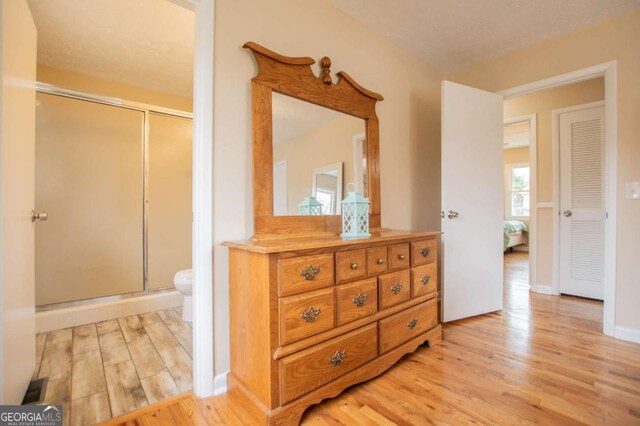 bedroom with a closet and light hardwood / wood-style floors