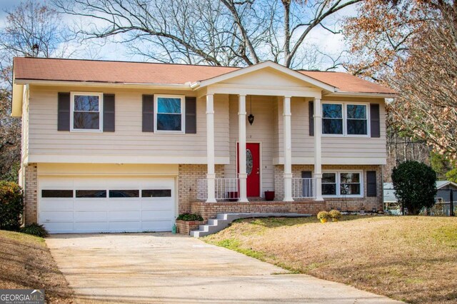 bi-level home featuring a garage and a front yard