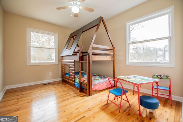 bedroom with ceiling fan and light wood-type flooring