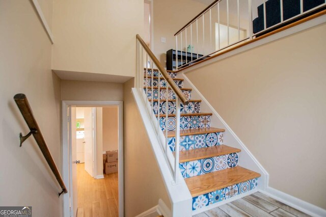 stairs featuring wood-type flooring