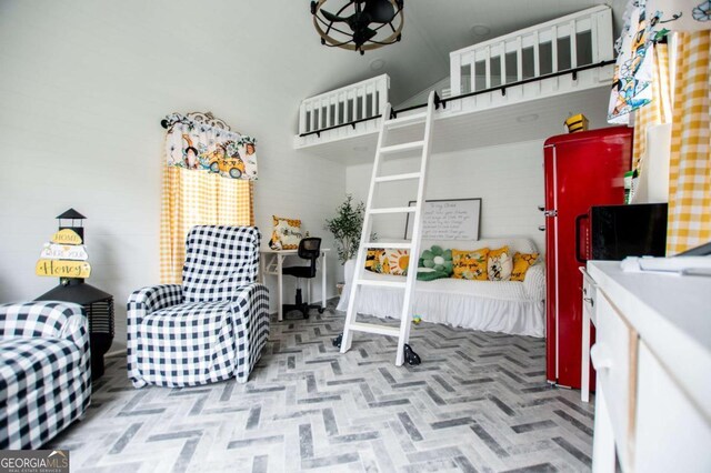 bedroom with high vaulted ceiling