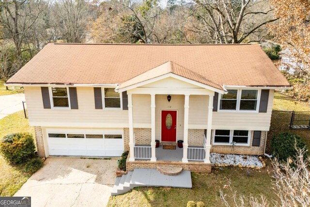 bi-level home with covered porch and a garage