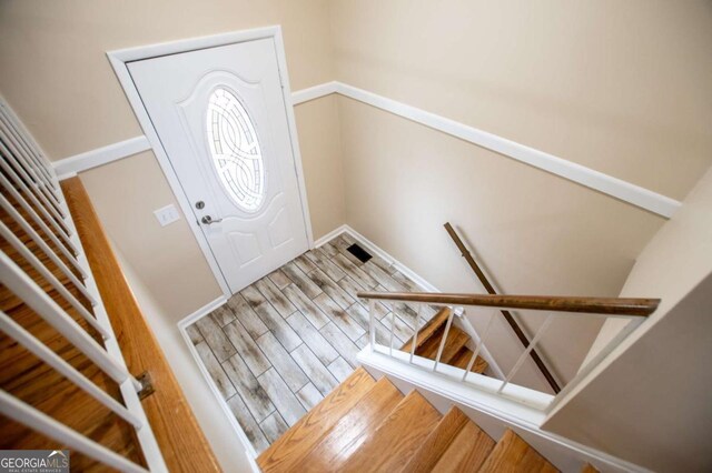 foyer entrance with hardwood / wood-style floors