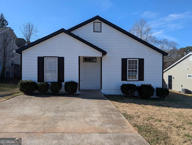 view of front of property with a front yard and cooling unit