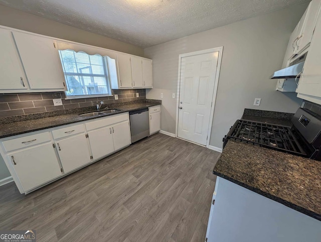 kitchen featuring white cabinets, stainless steel dishwasher, black range oven, and sink