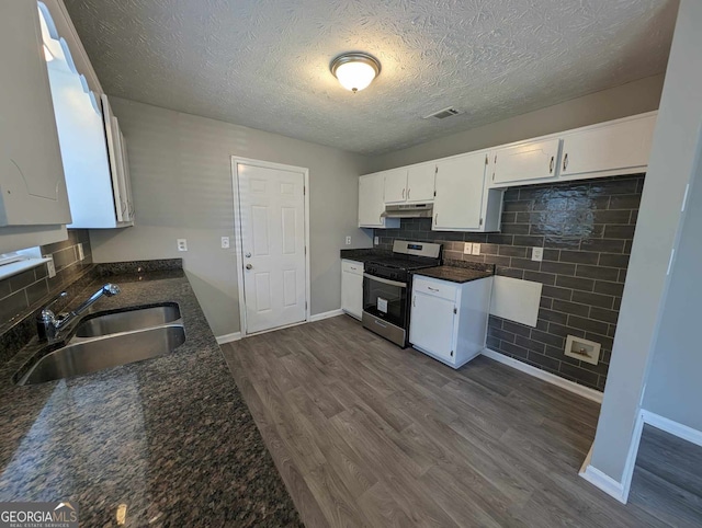 kitchen with electric range, sink, dark hardwood / wood-style flooring, a textured ceiling, and white cabinets