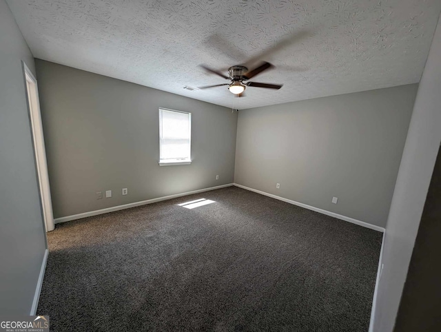 carpeted spare room with ceiling fan and a textured ceiling