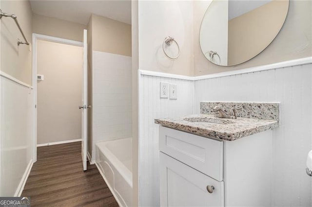 bathroom with shower / tub combination, vanity, and hardwood / wood-style flooring