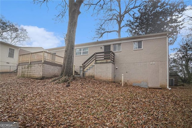 rear view of property featuring a wooden deck