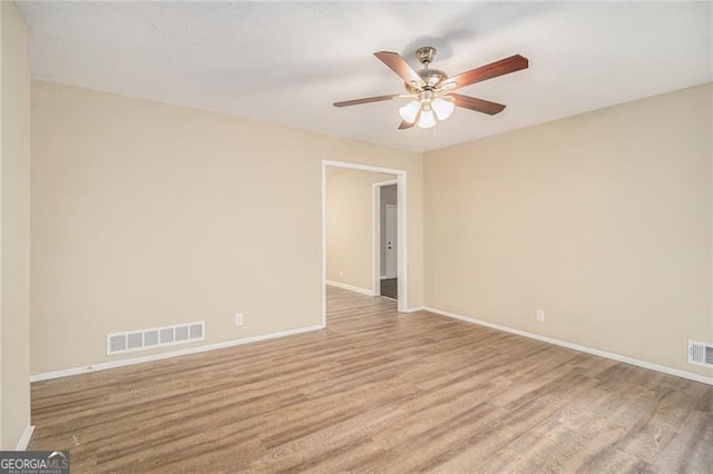 spare room featuring light hardwood / wood-style floors and ceiling fan