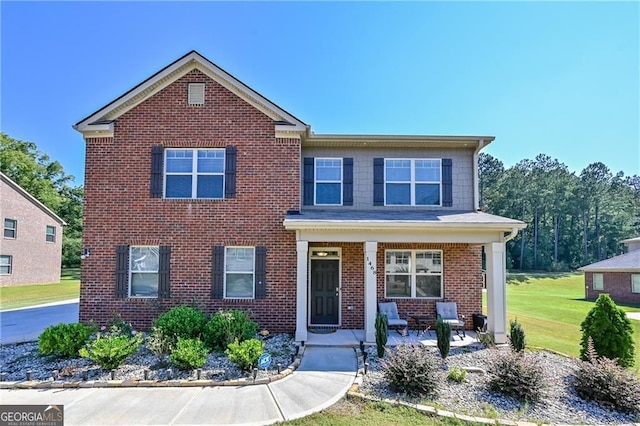 view of front of home with a front yard and a porch