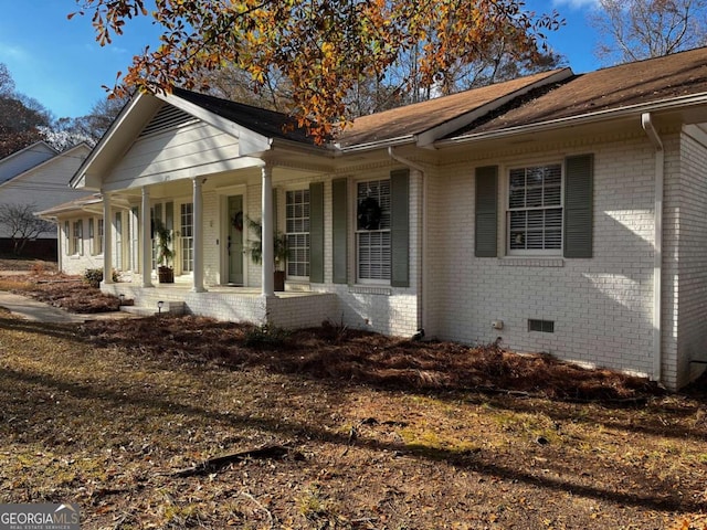 view of side of home with a porch