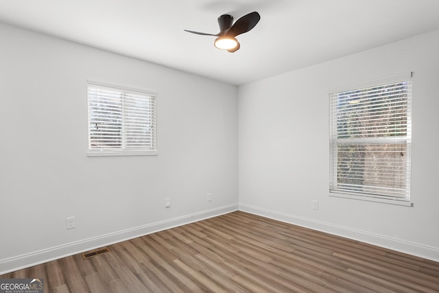 empty room featuring ceiling fan and dark hardwood / wood-style floors