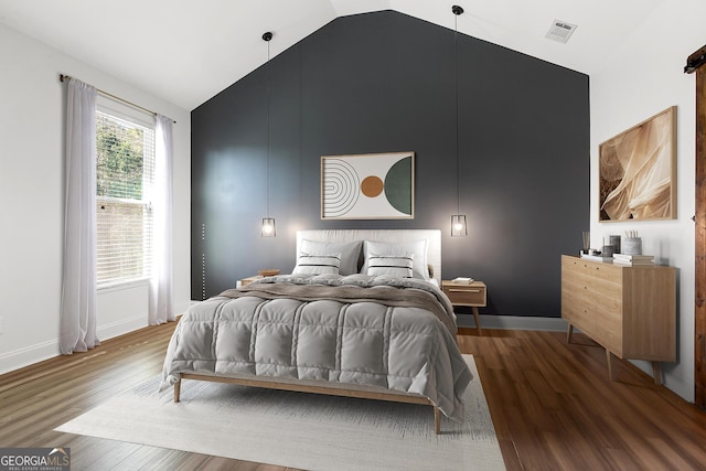 bedroom featuring wood-type flooring and vaulted ceiling