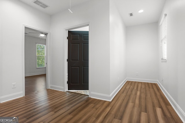 hall with dark wood-type flooring