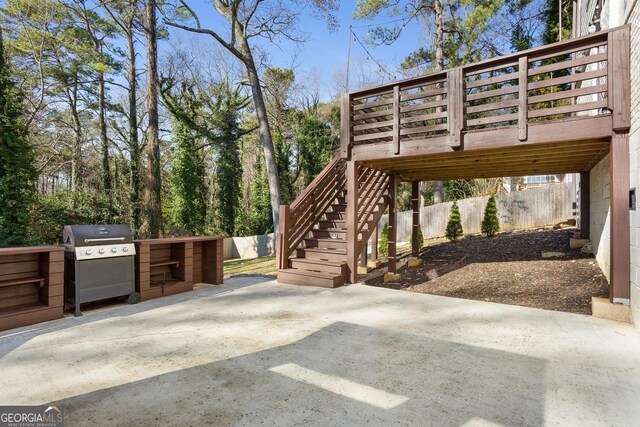 view of patio / terrace with area for grilling, a wooden deck, and grilling area