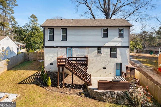 rear view of house with a yard and a deck