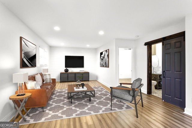 living room featuring hardwood / wood-style floors, plenty of natural light, and a barn door