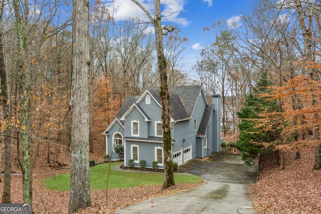 view of front of house with a garage and a front yard