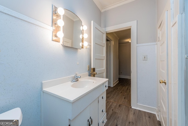 bathroom featuring vanity, hardwood / wood-style flooring, and crown molding