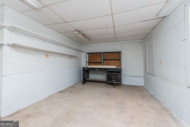 basement featuring a paneled ceiling