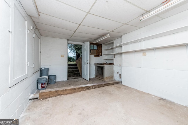 basement featuring a paneled ceiling