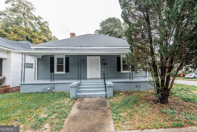 bungalow-style house with a porch and a front yard